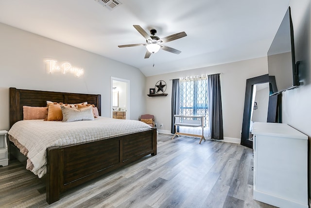 bedroom featuring lofted ceiling, baseboards, visible vents, and light wood finished floors