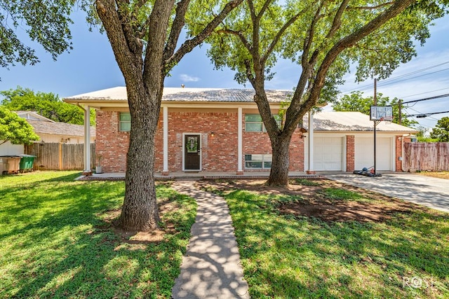 2113 Sul Ross St, San Angelo, TX 76904 - view of front facade with concrete driveway, brick siding, and an attached garage