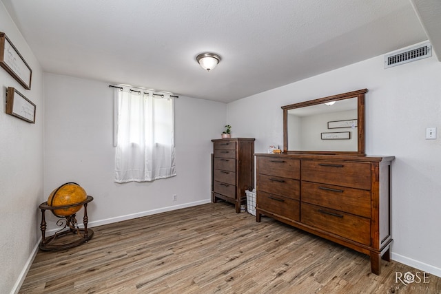 2113 Sul Ross St, San Angelo, TX 76904 - bedroom featuring wood finished floors and baseboards