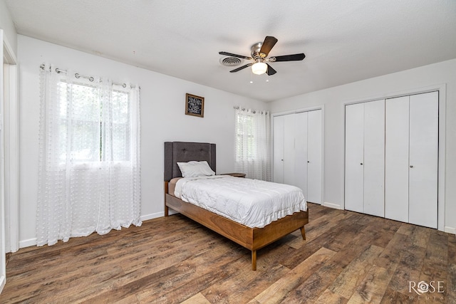 2113 Sul Ross St, San Angelo, TX 76904 - bedroom featuring wood finished floors, two closets, and ceiling fan