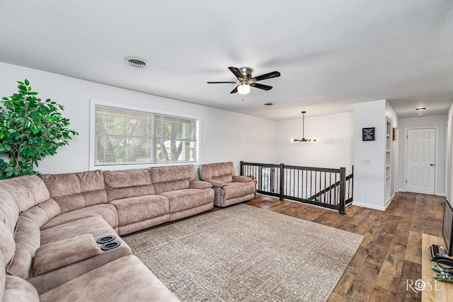 2113 Sul Ross St, San Angelo, TX 76904 - living room featuring dark wood-style flooring, a ceiling fan, and a chandelier