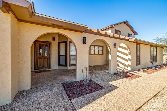 property entrance with stucco siding