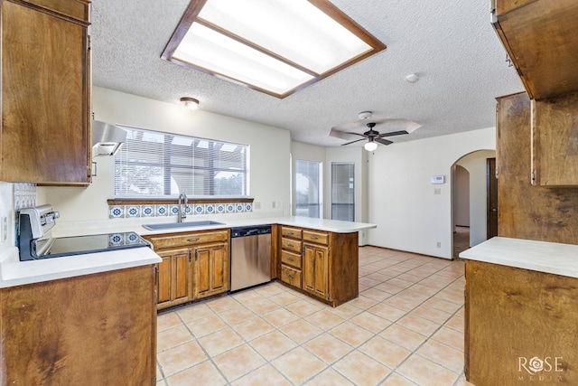 kitchen featuring electric range, stainless steel dishwasher, a sink, a peninsula, and exhaust hood