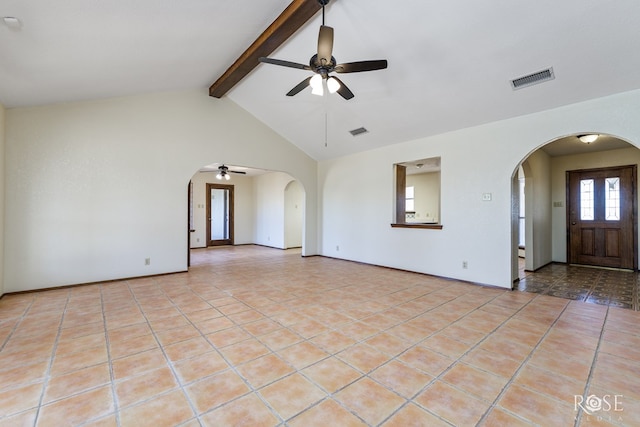 spare room featuring a ceiling fan, arched walkways, visible vents, and light tile patterned floors