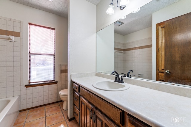 full bathroom featuring a textured ceiling, toilet, tile walls, vanity, and tile patterned floors