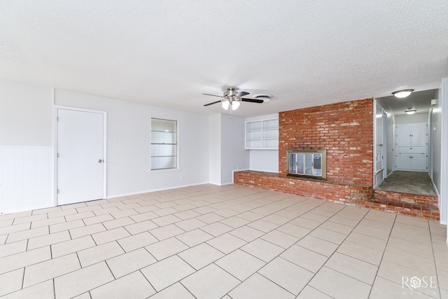 2109 Dartmouth Dr, San Angelo, TX 76904 - unfurnished living room with a ceiling fan, a textured ceiling, and a fireplace