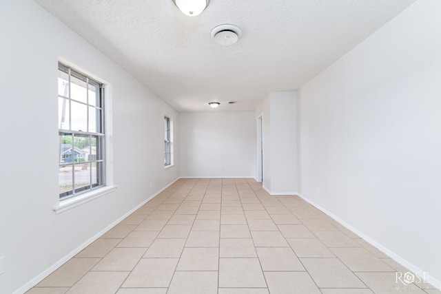 2109 Dartmouth Dr, San Angelo, TX 76904 - unfurnished room with a textured ceiling, baseboards, and light tile patterned floors