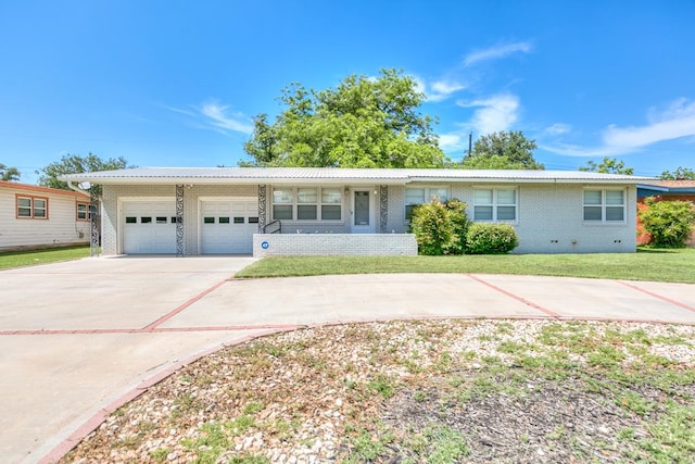 2650 Rice Ave, San Angelo, TX 76904 - ranch-style house featuring a garage, brick siding, concrete driveway, and a front lawn