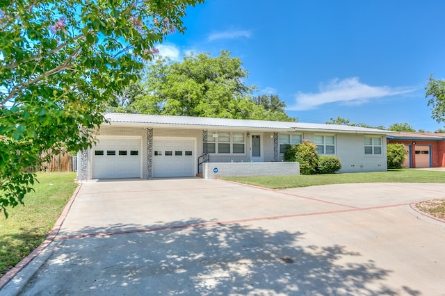 2650 Rice Ave, San Angelo, TX 76904 - single story home with an attached garage, concrete driveway, a front lawn, and brick siding