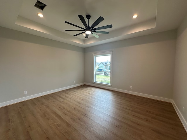 3609 Clearview Dr, San Angelo, TX 76904 - empty room with a raised ceiling, wood finished floors, baseboards, recessed lighting, and ceiling fan