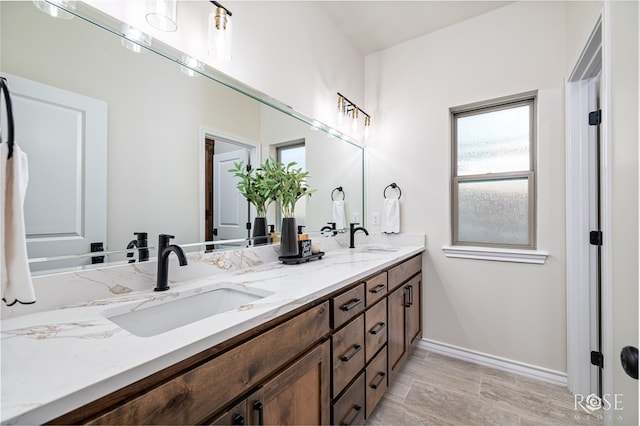 5034 Scarlet Oak Ln, San Angelo, TX 76904 - full bathroom featuring double vanity, healthy amount of natural light, and baseboards
