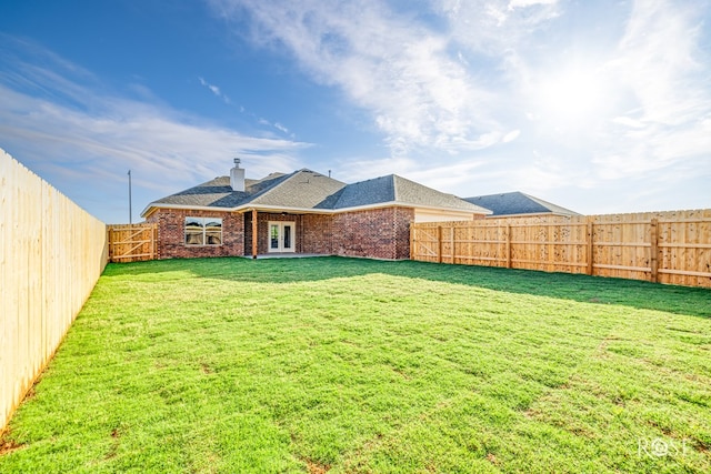 5034 Scarlet Oak Ln, San Angelo, TX 76904 - back of property with brick siding, a chimney, french doors, and a shingled roof