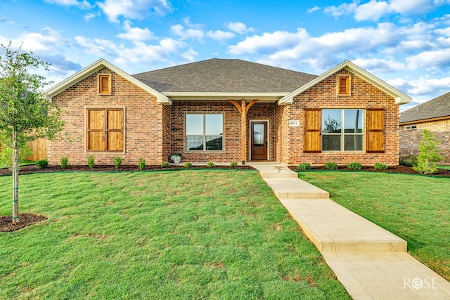 5034 Scarlet Oak Ln, San Angelo, TX 76904 - view of front of property featuring brick siding, a front yard, and a shingled roof
