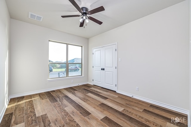 5034 Scarlet Oak Ln, San Angelo, TX 76904 - unfurnished bedroom featuring wood finished floors, baseboards, and a ceiling fan