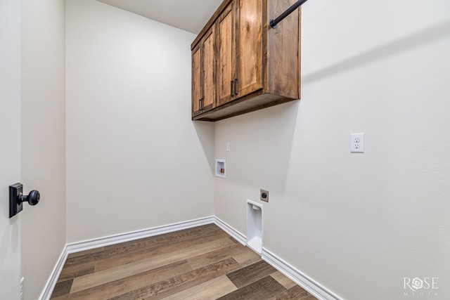 5034 Scarlet Oak Ln, San Angelo, TX 76904 - laundry area with electric dryer hookup, hookup for a washing machine, wood finished floors, cabinet space, and baseboards