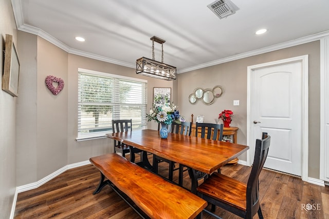 dining room featuring ornamental molding and dark hardwood / wood-style floors