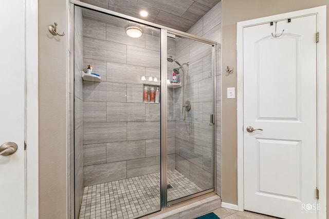 bathroom featuring a shower with door