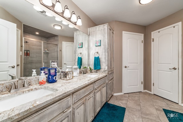 bathroom with tile patterned floors, a shower with shower door, and vanity