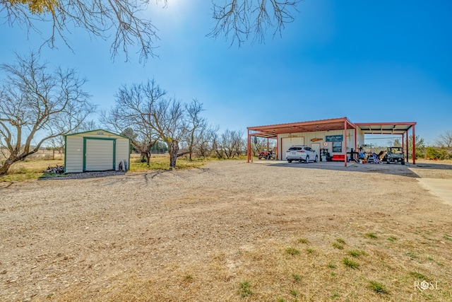 view of yard with a carport and a storage shed