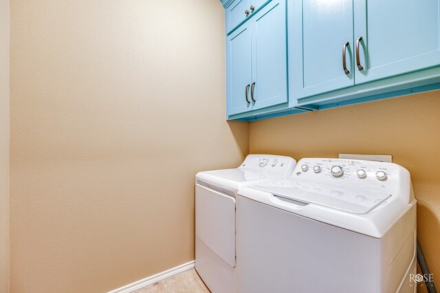 laundry room featuring baseboards, cabinet space, and washer and dryer