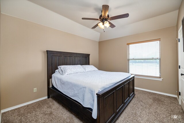 bedroom featuring vaulted ceiling, ceiling fan, baseboards, and light colored carpet