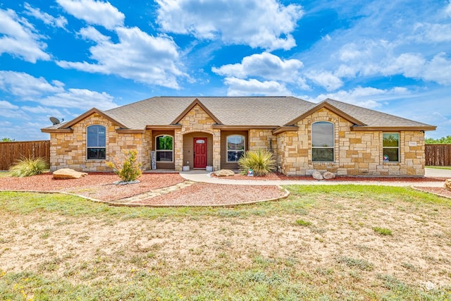 view of front of property featuring a shingled roof and fence