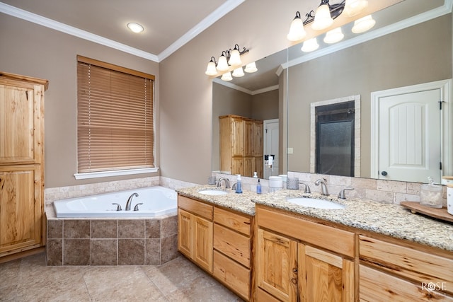 bathroom featuring a garden tub, double vanity, ornamental molding, and a sink