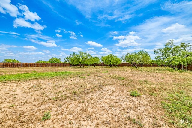 view of yard featuring a rural view and fence