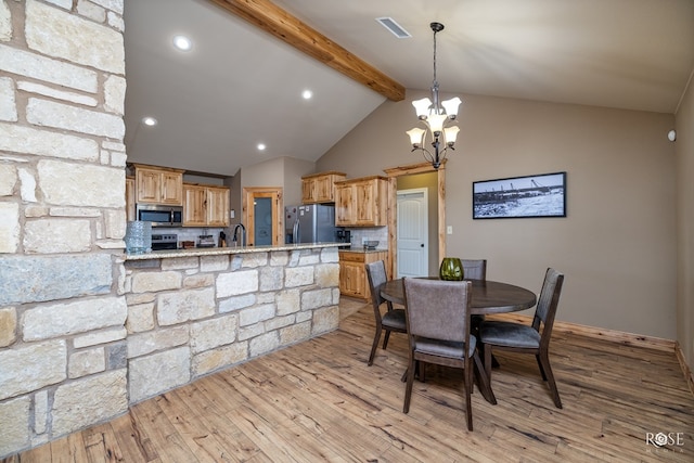 dining space featuring recessed lighting, a notable chandelier, visible vents, light wood finished floors, and beamed ceiling