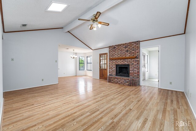 5821 Davenport Dr, San Angelo, TX 76901 - unfurnished living room with wood finished floors, a ceiling fan, a fireplace, a chandelier, and baseboards