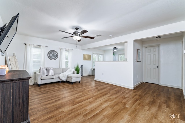 unfurnished living room featuring ceiling fan and wood-type flooring