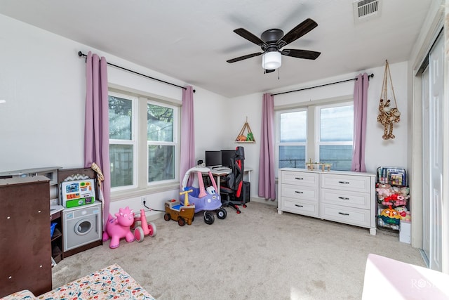 recreation room with plenty of natural light, light colored carpet, and ceiling fan