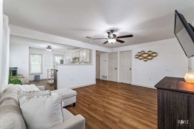 living room with dark wood-type flooring and ceiling fan