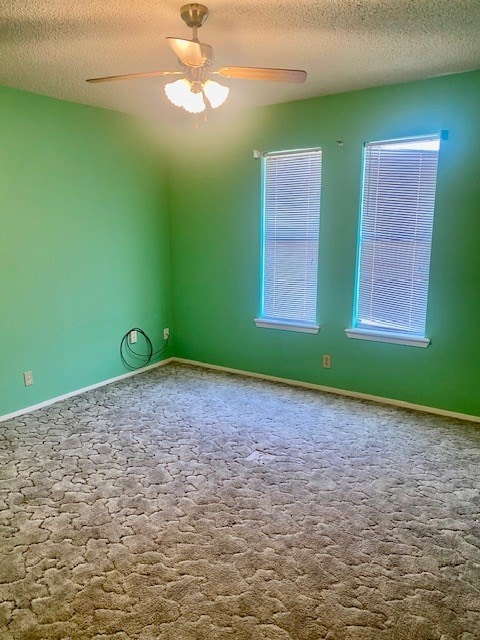 8882 Fm 765, San Angelo, TX 76905 - unfurnished room featuring a textured ceiling, ceiling fan, carpet flooring, and baseboards