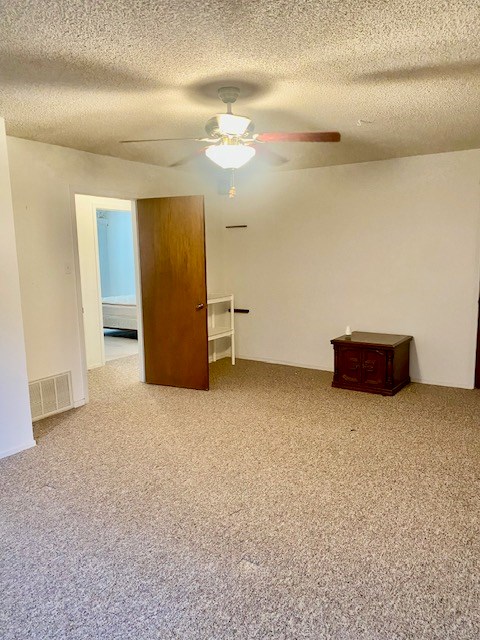 8882 Fm 765, San Angelo, TX 76905 - carpeted spare room with ceiling fan and a textured ceiling