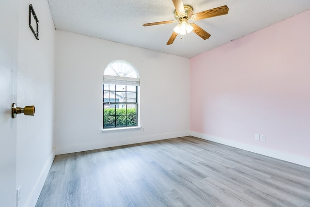 1605 Amberton Pkwy, San Angelo, TX 76901 - unfurnished room with wood finished floors, baseboards, a textured ceiling, and ceiling fan