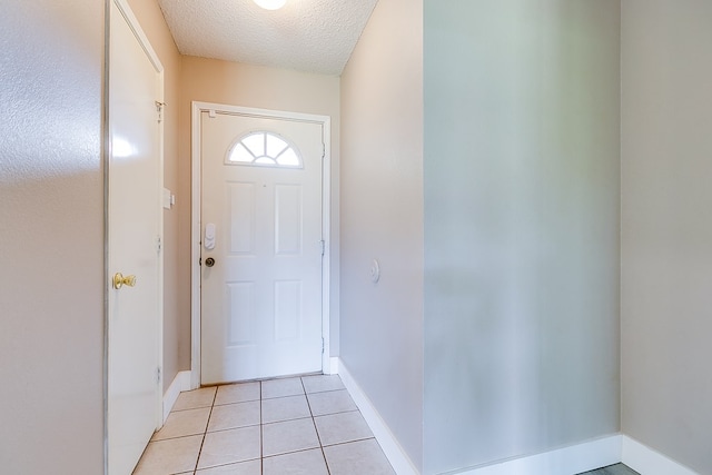 1605 Amberton Pkwy, San Angelo, TX 76901 - doorway featuring a textured ceiling, baseboards, and light tile patterned flooring