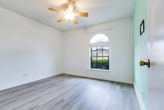 1605 Amberton Pkwy, San Angelo, TX 76901 - unfurnished room with wood finished floors, a textured ceiling, ceiling fan, and baseboards