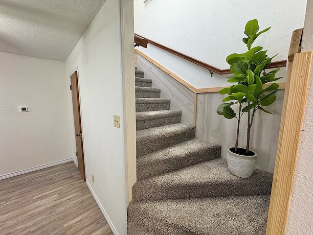 1036 Glenna Dr, San Angelo, TX 76901 - staircase with a textured ceiling and wood finished floors