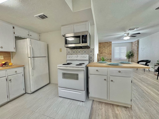 1036 Glenna Dr, San Angelo, TX 76901 - kitchen with white appliances, a textured ceiling, backsplash, a peninsula, and a ceiling fan