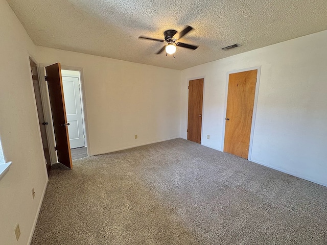 1036 Glenna Dr, San Angelo, TX 76901 - unfurnished bedroom with carpet, a ceiling fan, and a textured ceiling