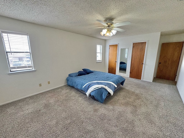 1036 Glenna Dr, San Angelo, TX 76901 - carpeted bedroom with multiple windows, a textured ceiling, and ceiling fan