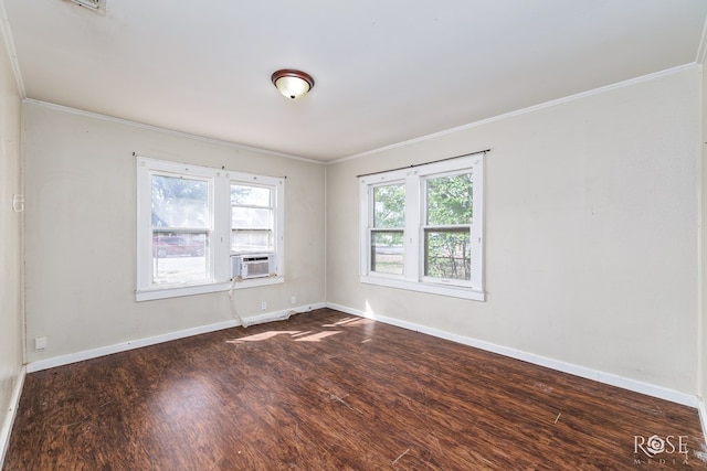 empty room with dark wood finished floors, baseboards, ornamental molding, and cooling unit