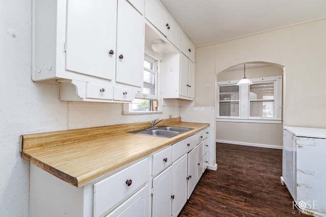 kitchen featuring white cabinetry, light countertops, and a sink