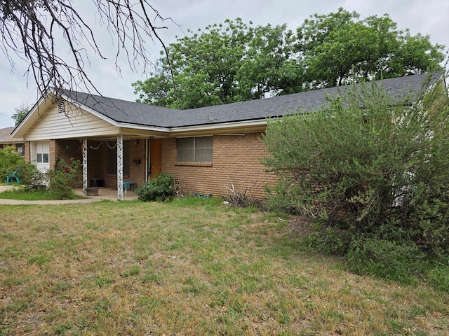 233 Robin Hood Trl, San Angelo, TX 76901 - single story home with brick siding, a front lawn, and a porch