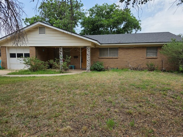 233 Robin Hood Trl, San Angelo, TX 76901 - ranch-style house with brick siding, a front yard, a garage, and roof with shingles