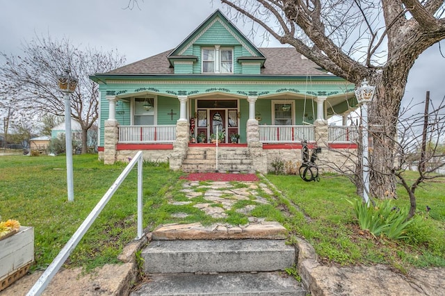 victorian-style house with a porch and a front yard