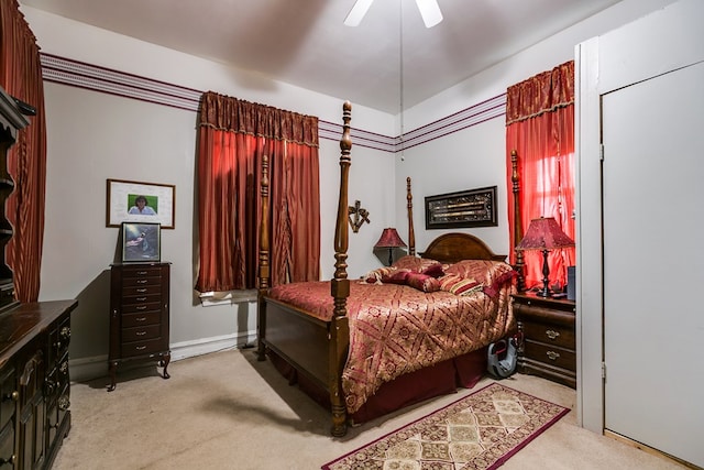 bedroom with ceiling fan and light carpet