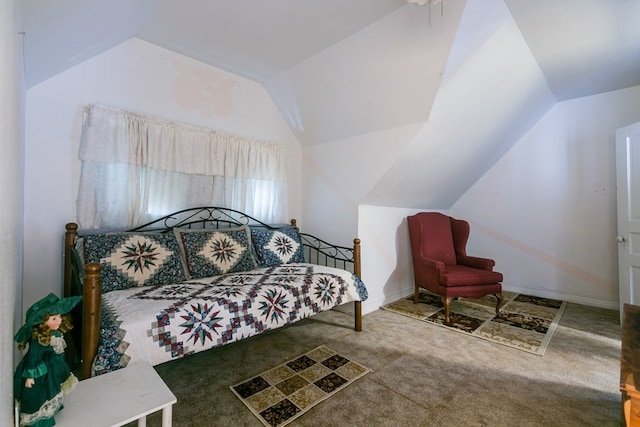 bedroom with carpet floors and vaulted ceiling