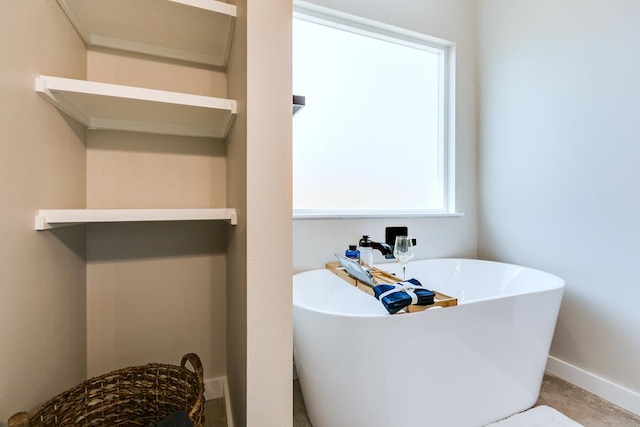 2122 Deaton St, San Angelo, TX 76903 - full bath featuring a freestanding tub and baseboards